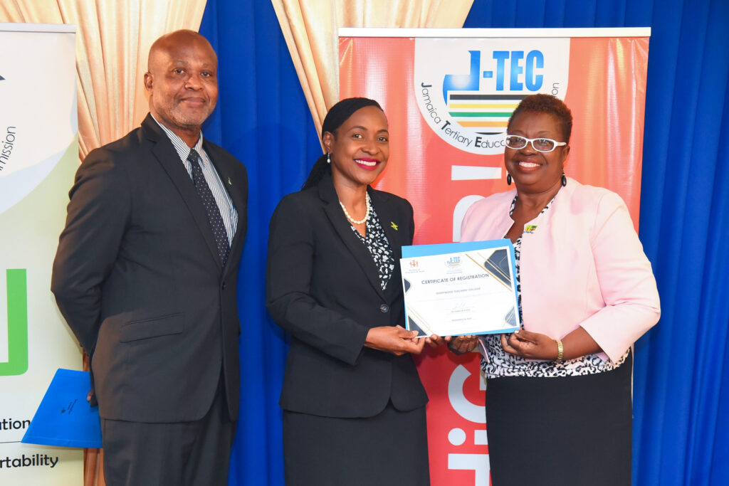 Minister of State in the Ministry of Education and Youth, Hon. Marsha Smith (centre), presents the Jamaica Tertiary Education Commission (J-TEC) Certificate of Registration, to Acting Principal of Shortwood Teachers’ College, Dr. Claudette Barrett March (right). Occasion was a ceremony for the award of certificates of registration to tertiary institutions on Wednesday (November 29), at the Courtleigh Hotel in New Kingston. Sharing in the presentation is J-TEC Commissioner and Executive Director, Dr. Dameon Black.