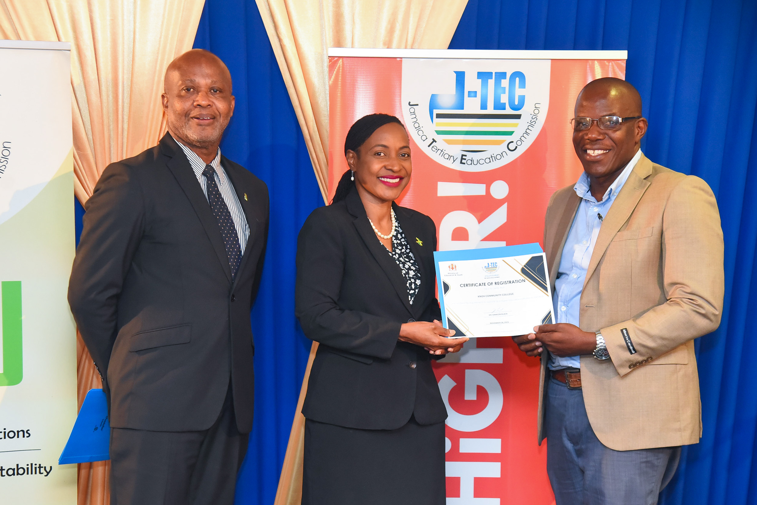 Minister of State in the Ministry of Education and Youth, Hon. Marsha Smith (centre), presents the Jamaica Tertiary Education Commission (J-TEC) Certificate of Registration to Acting Vice Principal for Student Services at Knox Community College, Euton Gordon (right). Occasion was a ceremony for the award of certificates of registration to tertiary institutions on Wednesday (November 29), at the Courtleigh Hotel in New Kingston. Sharing in the presentation is J-TEC Commissioner and Executive Director, Dr. Dameon Black.